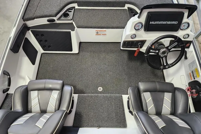 Slide: The Image of Interior of a 2021 Nitro Z18 boat with steering wheel and seating. - 2