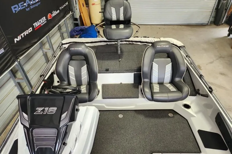 Slide: The Image of 2021 Nitro Z18 boat interior with three seats and steering console. - 4