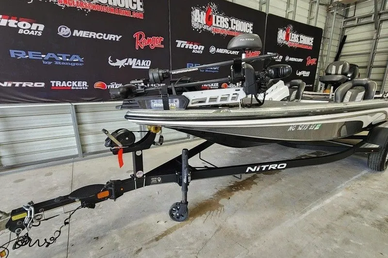 Slide: The Image of 2021 Nitro Z18 boat on trailer in showroom with branded backdrop. - 8