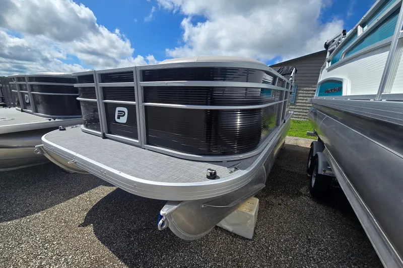 The Image of 2026 Princecraft Jazz 17 pontoon boat with sleek design, parked outdoors under blue sky. - 0