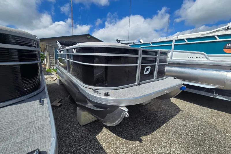 Slide: The Image of 2026 Princecraft Jazz 17 pontoon boat displayed outdoors under a blue sky. - 5