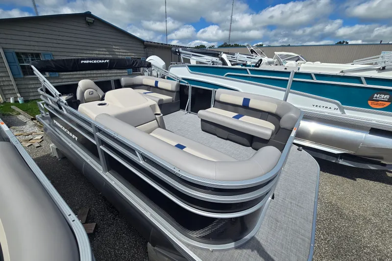 Slide: The Image of 2026 Princecraft Jazz 17 pontoon boat with spacious seating, docked outdoors. - 4
