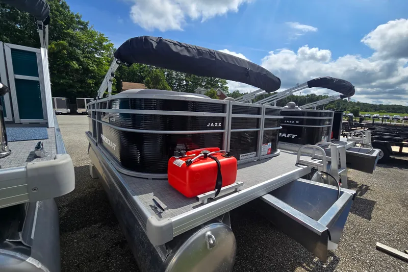 Slide: The Image of 2026 Princecraft Jazz 17 pontoon boat with canopy and red fuel container. - 2