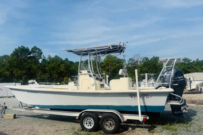 The Image of 2015 Jones Brothers Bateau 23 boat on trailer with Yamaha engine, parked outdoors. - 1
