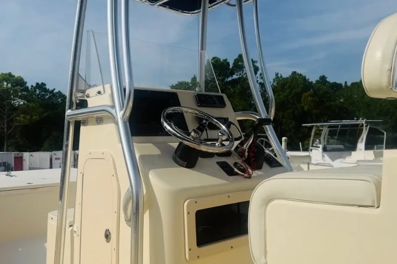 Slide: The Image of Center console of a 2015 Jones Brothers Bateau 23 boat with steering wheel and controls. - 7