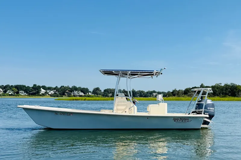The Image of 2015 Jones Brothers Bateau 23 boat on calm water under clear blue sky. - 0