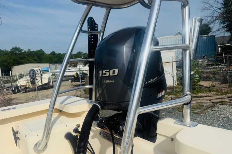 Slide: The Image of 2015 Jones Brothers Bateau 23 with Yamaha 150 outboard motor in a boatyard setting. - 5