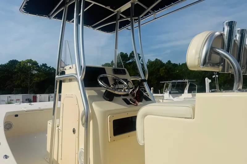 Slide: The Image of 2015 Jones Brothers Bateau 23 boat cockpit with steering wheel and seating. - 4