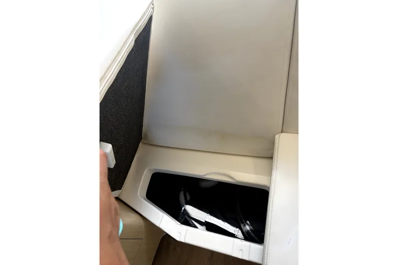 Slide: The Image of Interior storage compartment of 2025 Regal 33 Express boat with white upholstery. - 17
