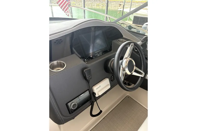 Slide: The Image of Helm of 2025 Regal 33 Express boat with modern steering and controls. - 15