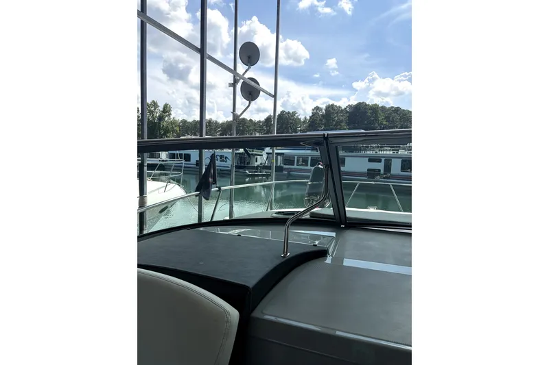 Slide: The Image of 2025 Regal 33 Express yacht interior view with marina backdrop. - 14