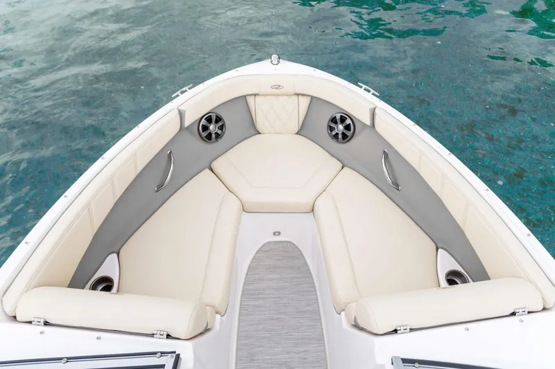 Slide: The Image of Manufacturer Provided Image: 2026 Regal 21 OBX boat interior with beige seating and speakers, on clear water. - 3
