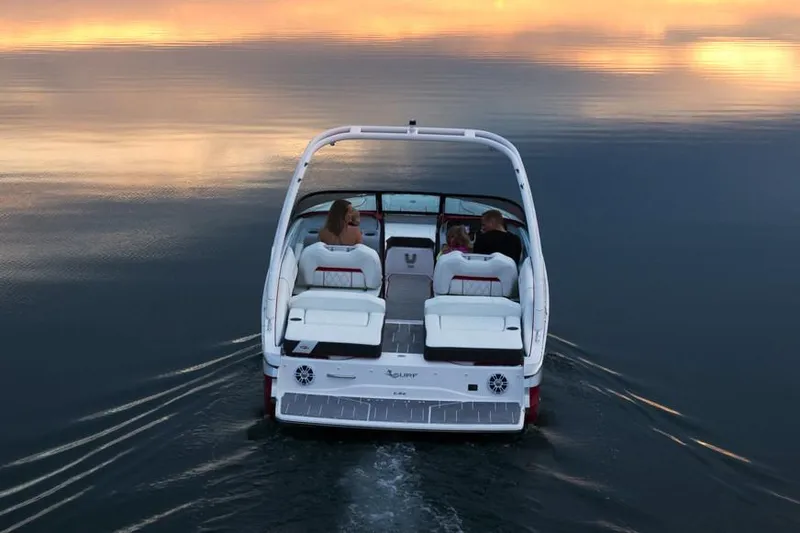 Slide: The Image of Manufacturer Provided Image: 2026 Regal LS2 Surf boat cruising on calm water at sunset. - 4