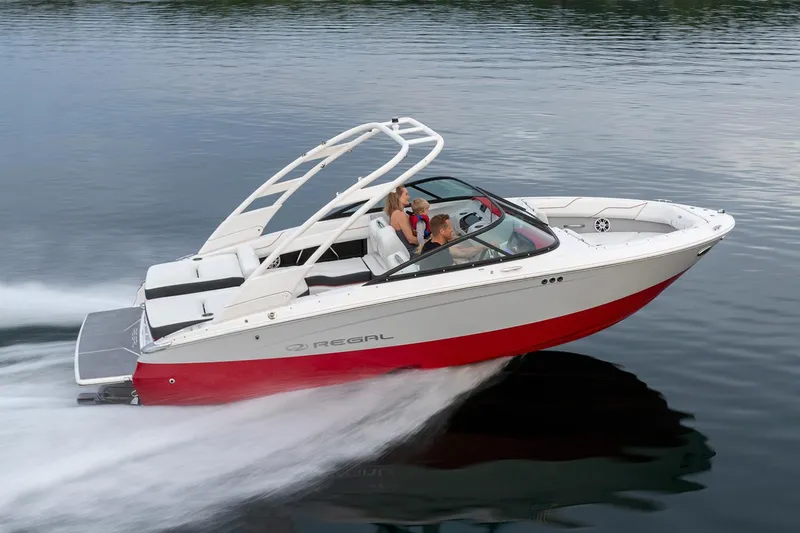 Slide: The Image of Manufacturer Provided Image: 2026 Regal LS2 Surf boat cruising on a calm lake. - 1