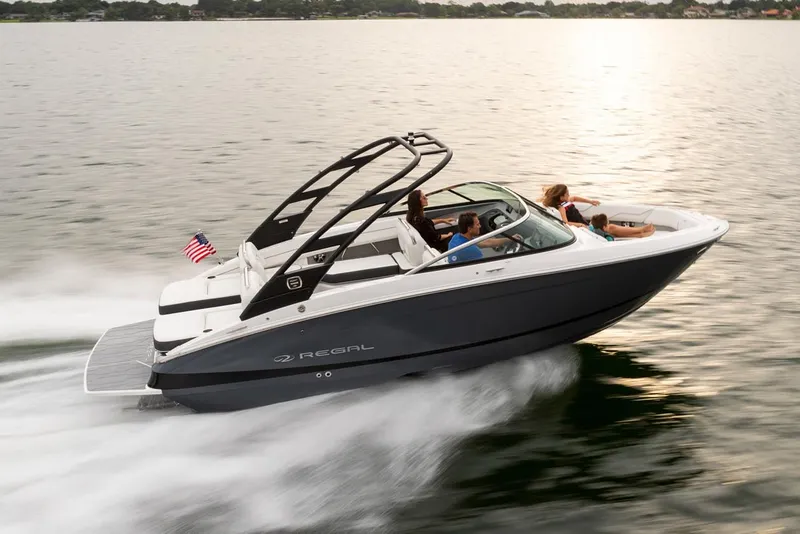 The Image of Manufacturer Provided Image: 2026 Regal LS4 boat cruising on a lake at sunset with passengers onboard. - 1