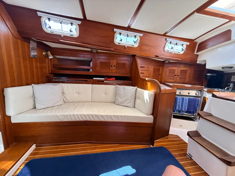 Slide: The Image of Interior of a 1992 Tartan T 31 with wood finish and beige sofa. - 13