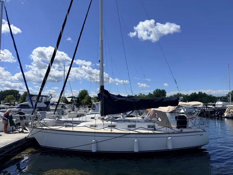 Slide: The Image of A 1992 Tartan T 31 sailboat docked on a sunny day in the harbor. - 1