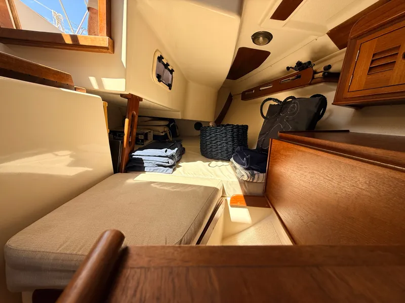 Slide: The Image of Interior of a 1992 Tartan T 31 with wooden furnishings and cozy seating. - 12