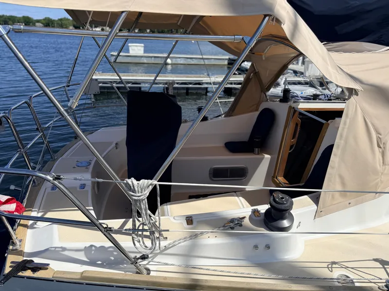 Slide: The Image of The image shows the cockpit of a 1992 Tartan T 31 with beige canopy and ropes. - 3