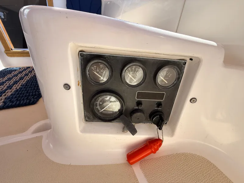 Slide: The Image of The image shows a control panel with several gauges and a red safety key. - 9