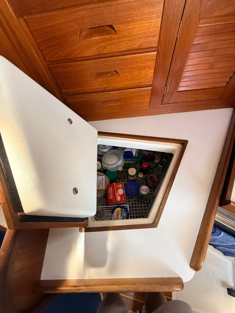 Slide: The Image of The image shows the interior of a 1992 Tartan T 31 with an open fridge. - 17