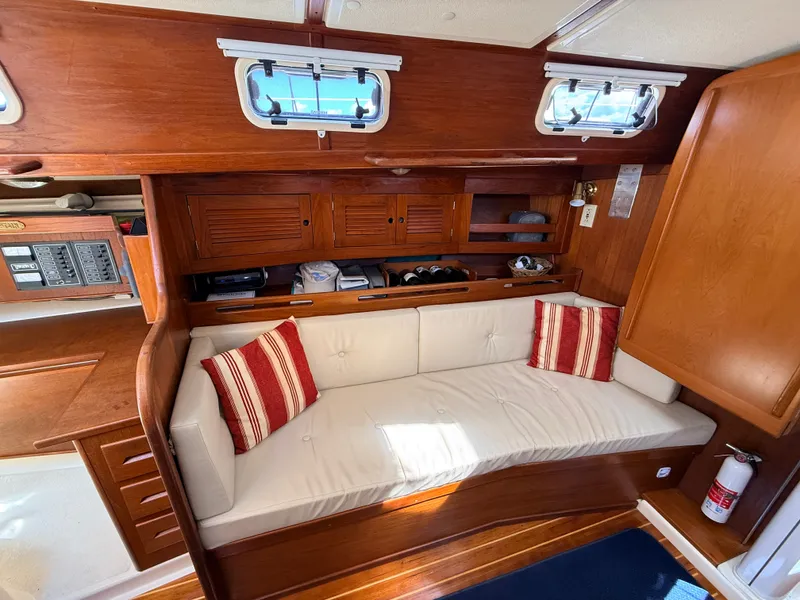 Slide: The Image of Interior of a 1992 Tartan T 31 with wood finish and beige sofa. - 11