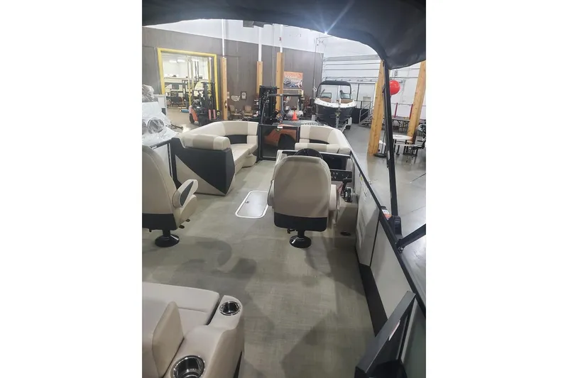 Slide: The Image of 2027 Alera A22L boat interior with beige seating and modern design in showroom. - 16