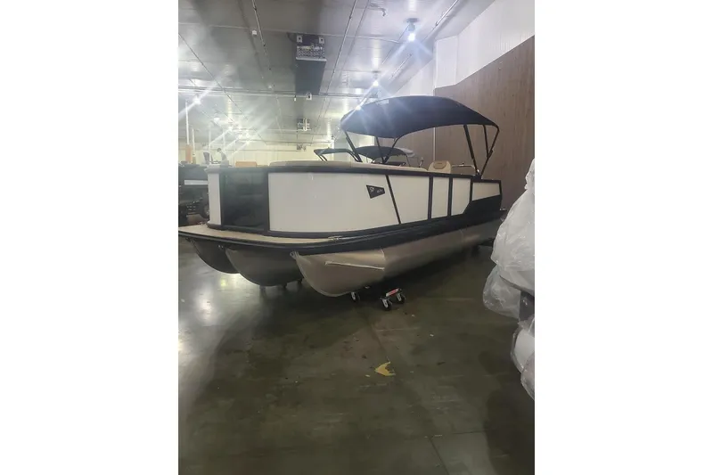 Slide: The Image of 2027 Alera A22L pontoon boat in indoor showroom with canopy. - 13
