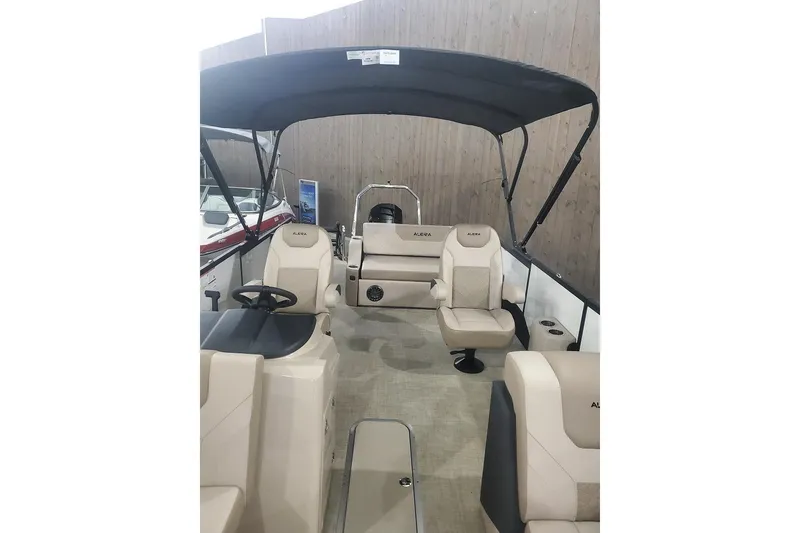 Slide: The Image of 2027 Alera A22L boat interior with beige seating and black canopy. - 19