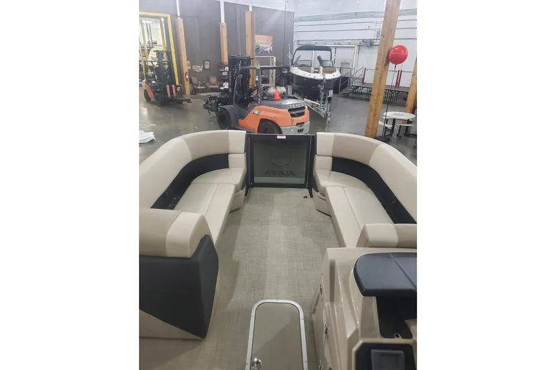 Slide: The Image of Interior view of 2027 Alera A22L boat with beige seating in a showroom. - 18