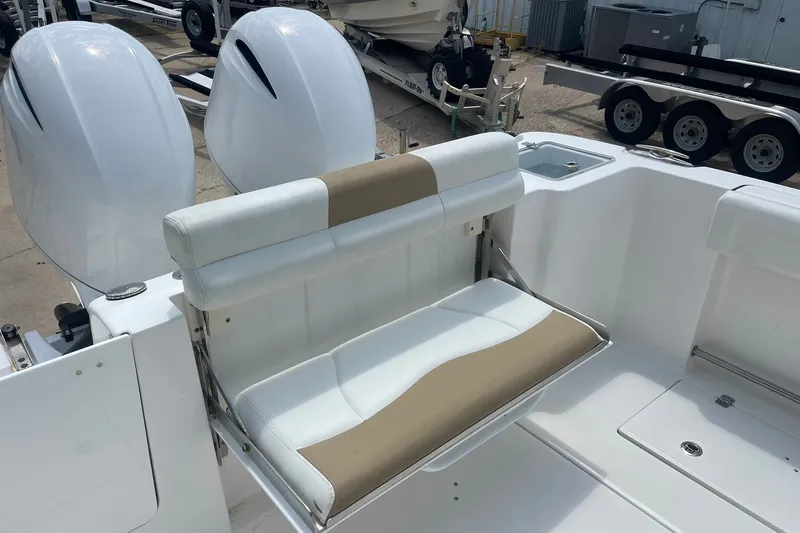 Slide: The Image of 2023 Edgewater 262CC boat with dual engines and cushioned seating. - 9