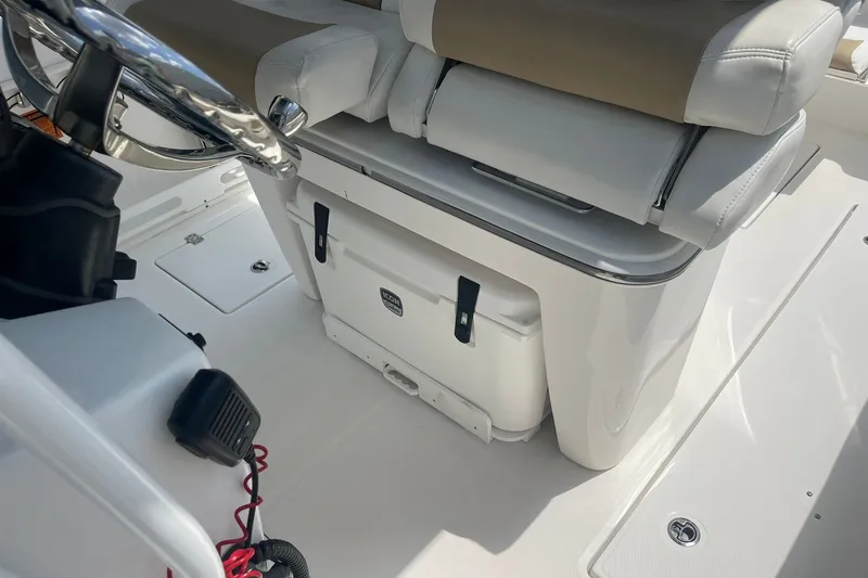 Slide: The Image of 2023 Edgewater 262CC boat interior with steering wheel and seating area. - 16