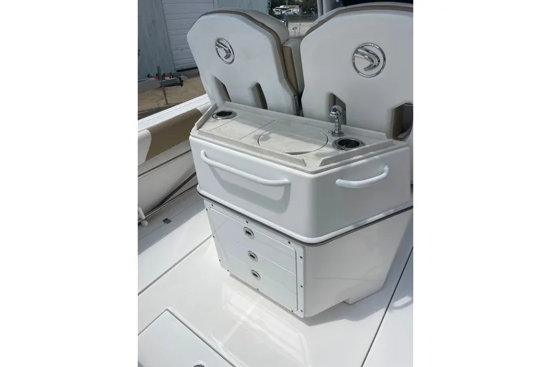 Slide: The Image of 2023 Edgewater 262CC boat interior with sink and storage compartments. - 10