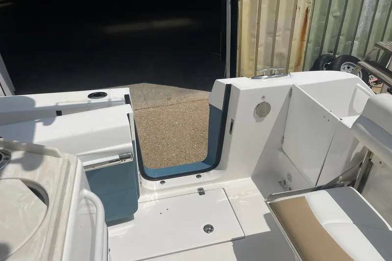 Slide: The Image of 2023 Edgewater 262CC boat interior with open door and seating area. - 24