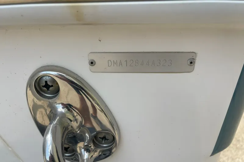 Slide: The Image of 2023 Edgewater 262CC boat hull identification number plate and metal fitting. - 21