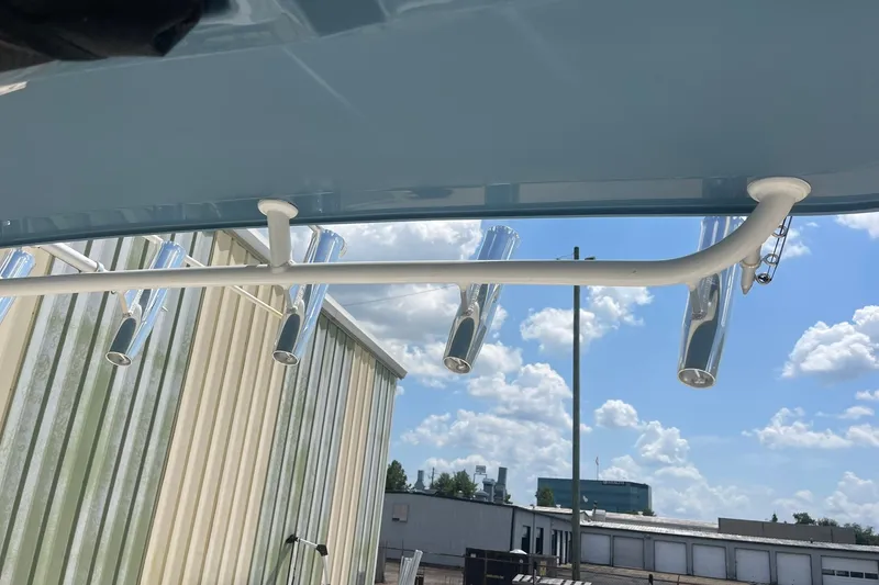 Slide: The Image of 2023 Edgewater 262CC boat rod holders under blue sky. - 22