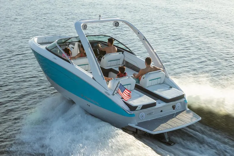 Slide: The Image of Manufacturer Provided Image: 2026 Regal LS4 Surf boat cruising on water with passengers enjoying the ride. - 1