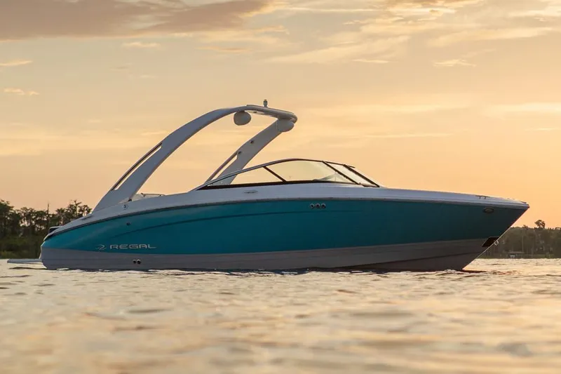 Slide: The Image of Manufacturer Provided Image: 2026 Regal LS4 Surf boat on calm water at sunset. - 4