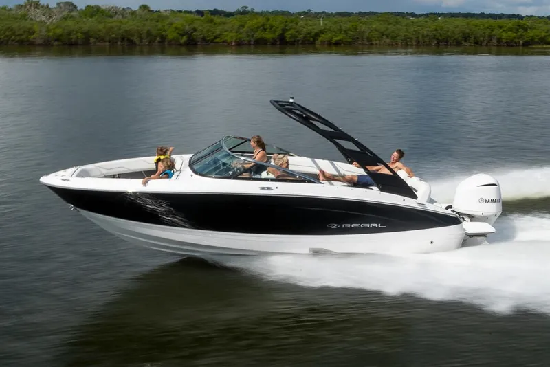The Image of Manufacturer Provided Image: 2026 Regal LX4 boat cruising on a calm lake with passengers enjoying the ride. - 0