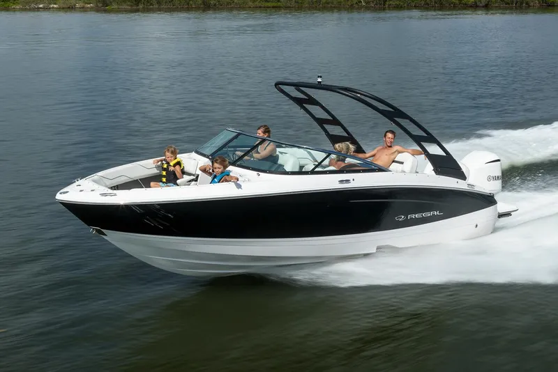 Slide: The Image of Manufacturer Provided Image: 2026 Regal LX4 boat cruising on a lake with passengers enjoying the ride. - 2