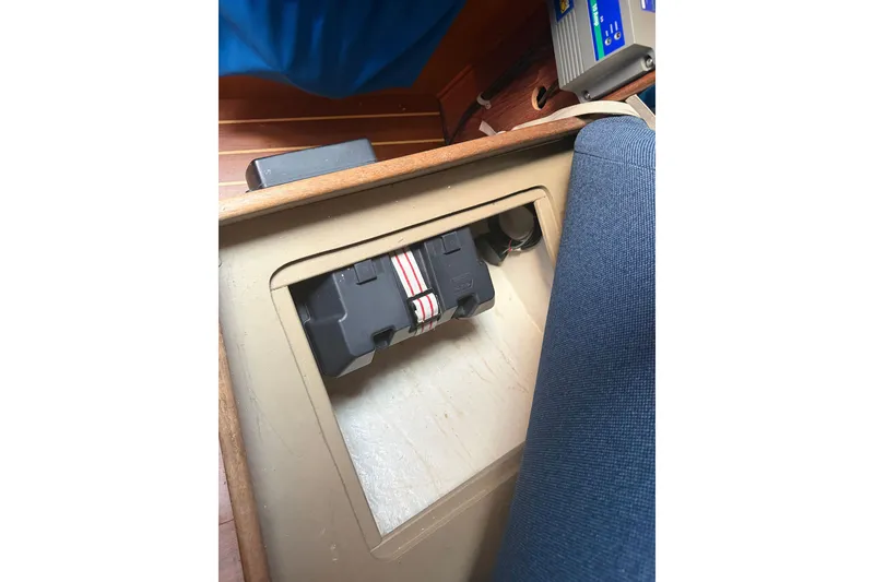 Slide: The Image of Battery compartment inside a 1984 C&C 33 MK II sailboat, featuring a secured battery. - 60