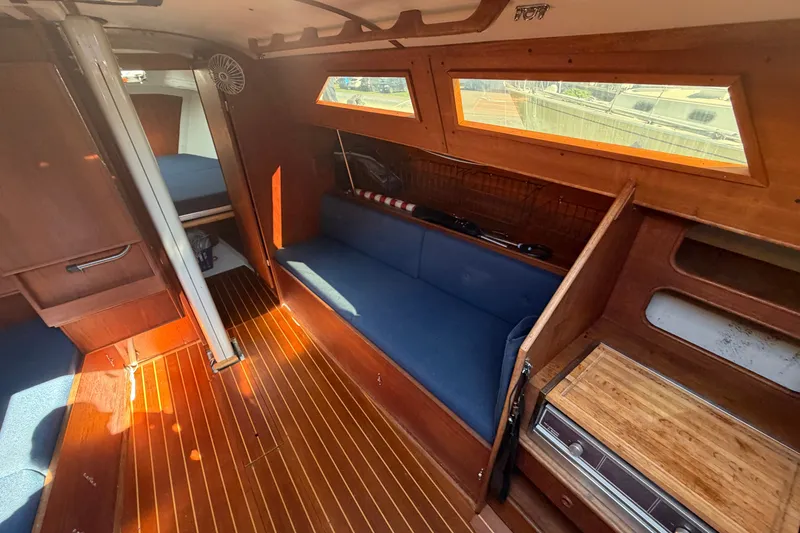 Slide: The Image of Interior of 1984 C&C 33 MK II sailboat with wooden finish and blue seating. - 35