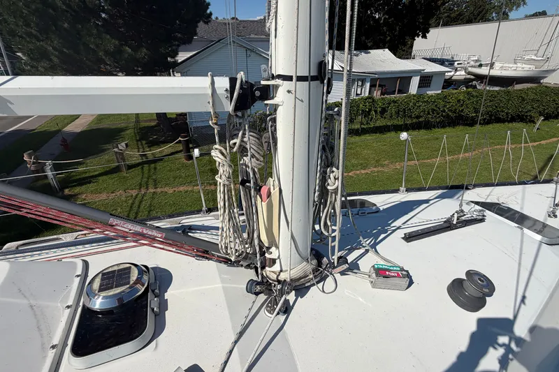 Slide: The Image of 1984 C&C 33 MK II sailboat deck with mast, rigging, and equipment in a marina setting. - 18