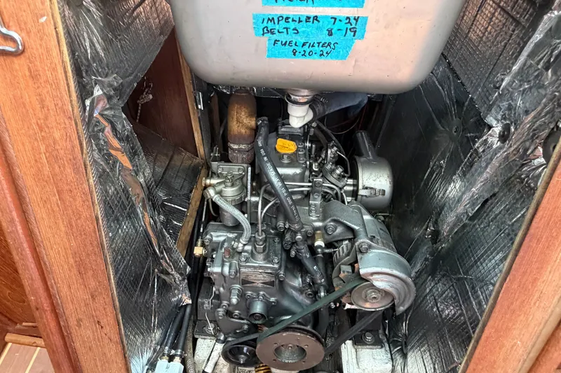 Slide: The Image of 1984 C&C 33 MK II engine compartment with maintenance notes on tank. - 63