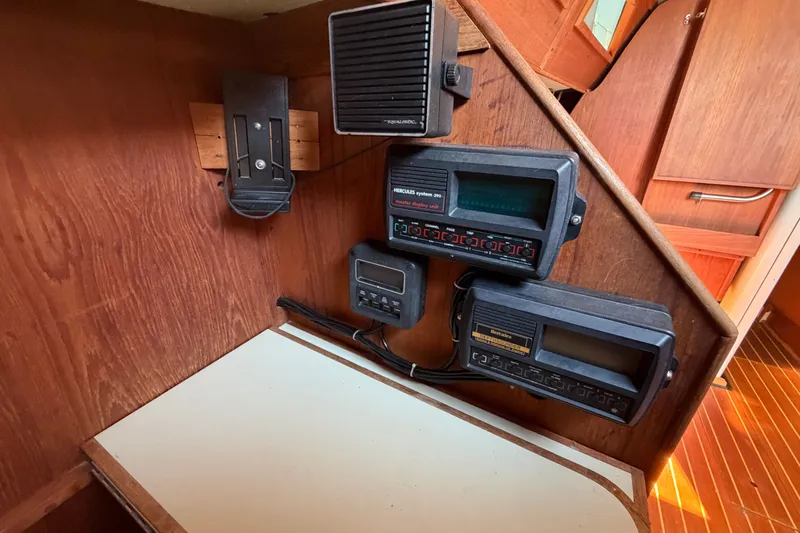 Slide: The Image of 1984 C&C 33 MK II yacht interior with navigation instruments and wooden paneling. - 39