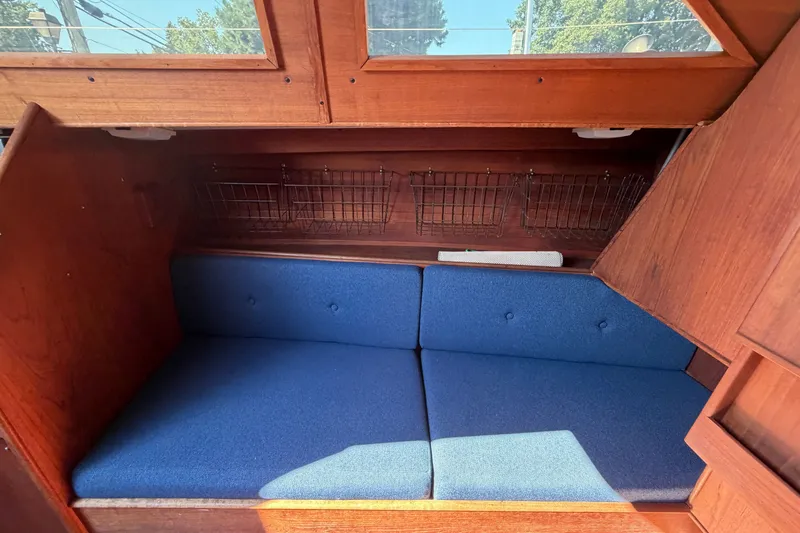 Slide: The Image of Interior of 1984 C&C 33 MK II sailboat with blue cushioned seating. - 46