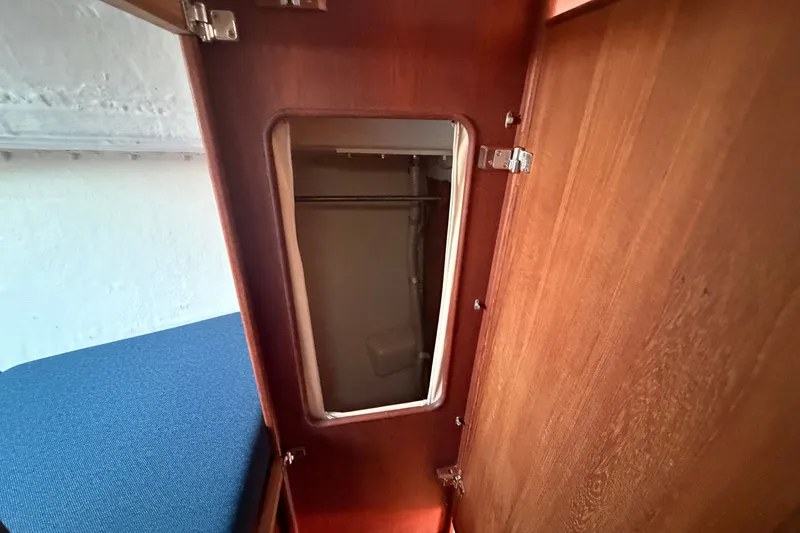 Slide: The Image of Interior view of a 1984 C&C 33 MK II sailboat closet with wooden finish. - 55