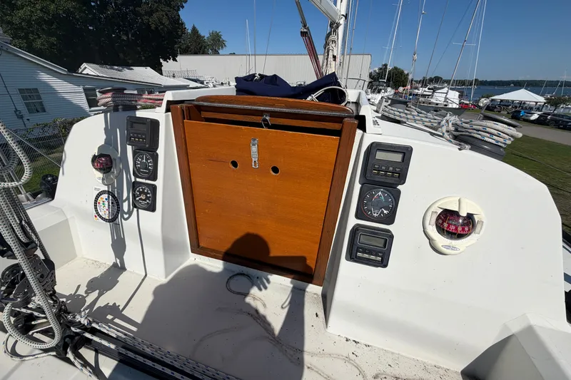 Slide: The Image of Cockpit of 1984 C&C 33 MK II sailboat with navigation instruments and wooden hatch. - 14