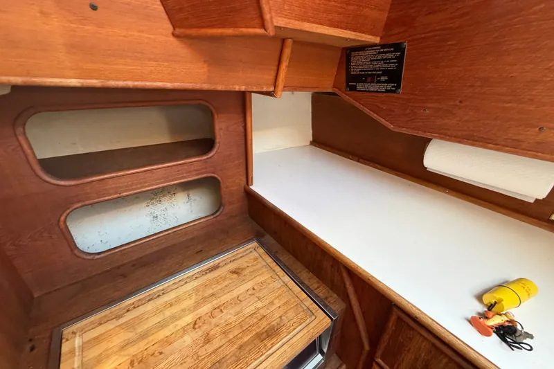 Slide: The Image of Interior of 1984 C&C 33 MK II sailboat with wooden cabinetry and countertop. - 44