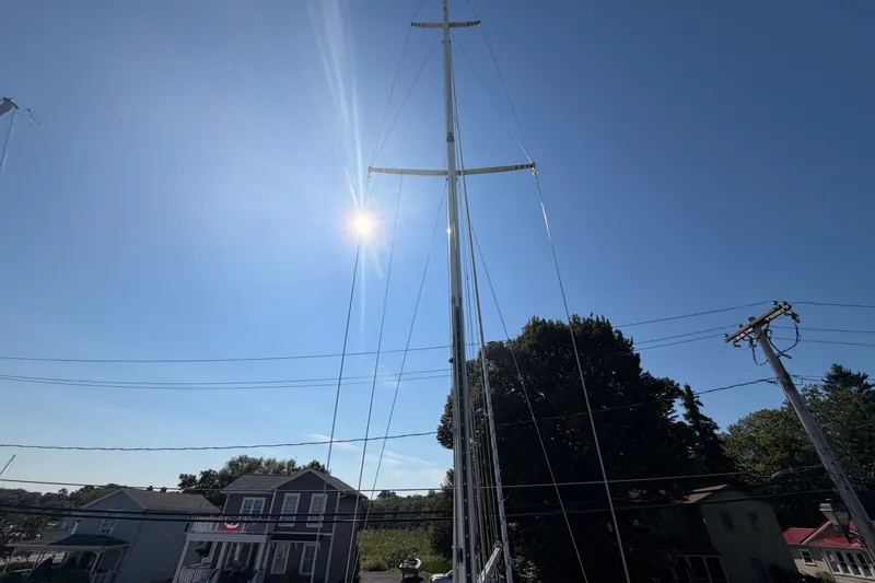 Slide: The Image of Tall sailboat mast of 1984 C&C 33 MK II against clear blue sky. - 25